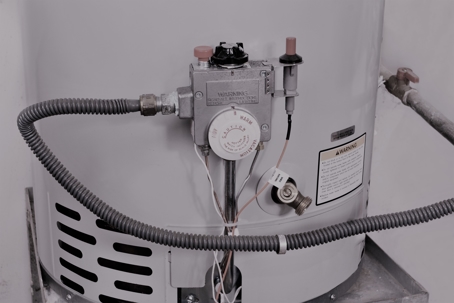 a close up of a water heater with the hose